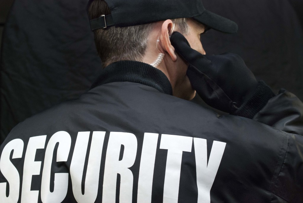 security guard at expo wearing a black jacket and earpiece